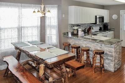 Alluring River dining table and kitchen with granite counter tops