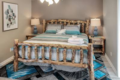 Alluring River main level bedroom 1 with king size log bed