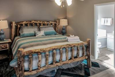 Alluring River Main Level Bedroom 1 with king size log bed