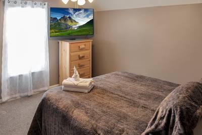 Alluring River upper level bedroom 3 with 55-inch TV