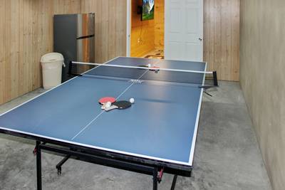 Alluring River lower level garage area with ping pong table