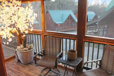 Spa Dee Dah main level screened in back deck with rocking chairs