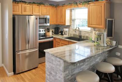 Striking Waters fully furnished kitchen with stainless steel appliances and granite countertops