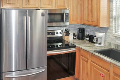 Striking Waters fully furnished kitchen with stainless steel appliances and granite countertops