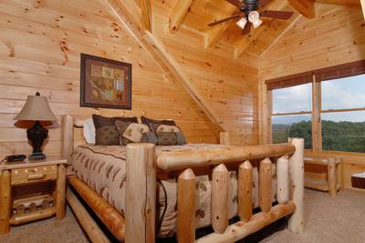 A Cabin of Dreams upper level bedroom with queen size bed