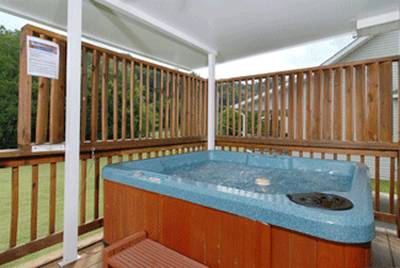 River Escape covered back deck with hot tub