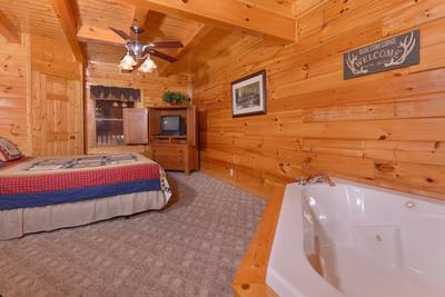 Pigeon Forge One Bedroom Cabin Rental that features a King Size Bed and Whirlpool in the Master Suite