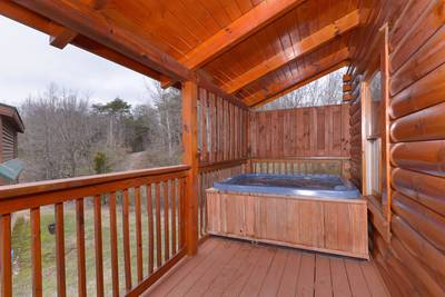 Pigeon Forge One Bedroom Plus loft Cabin Rental featuring a hot tub and outdoor pool access