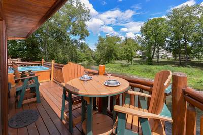 Down by the River back deck with high top table and chairs