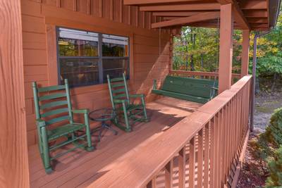 Serenity Ridge covered entry deck with wood swing