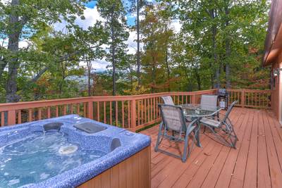 Serenity Ridge hot tub and table and chairs on back deck